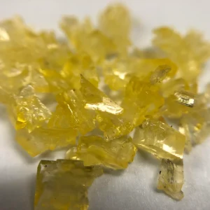 DMT crystal showing opaque white and yellow-tinted shards resembling glass or fine powder.